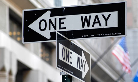 Traffic signs show "One Way" in two different directions.