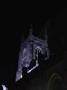 Holy Trinity tower illuminated at night.