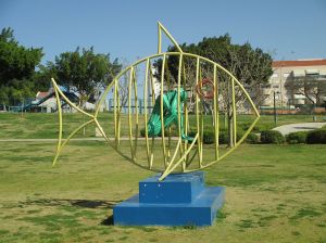 A playground climbing frame in the shape of a fish.
