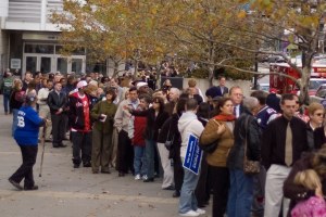 A crowd waiting outside a door.