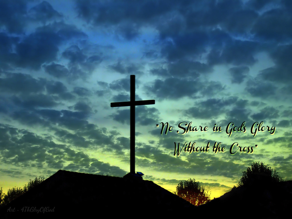 A sunrise or sunset scene showing a brightening or darkening turquoise sky with clouds unlit by sunlight. The foreground is black, in silhouette, showing houses and trees plus a large church cross against the sky. These words are superimposed on the right of the picture: "No Share in God's Glory Without the Cross."