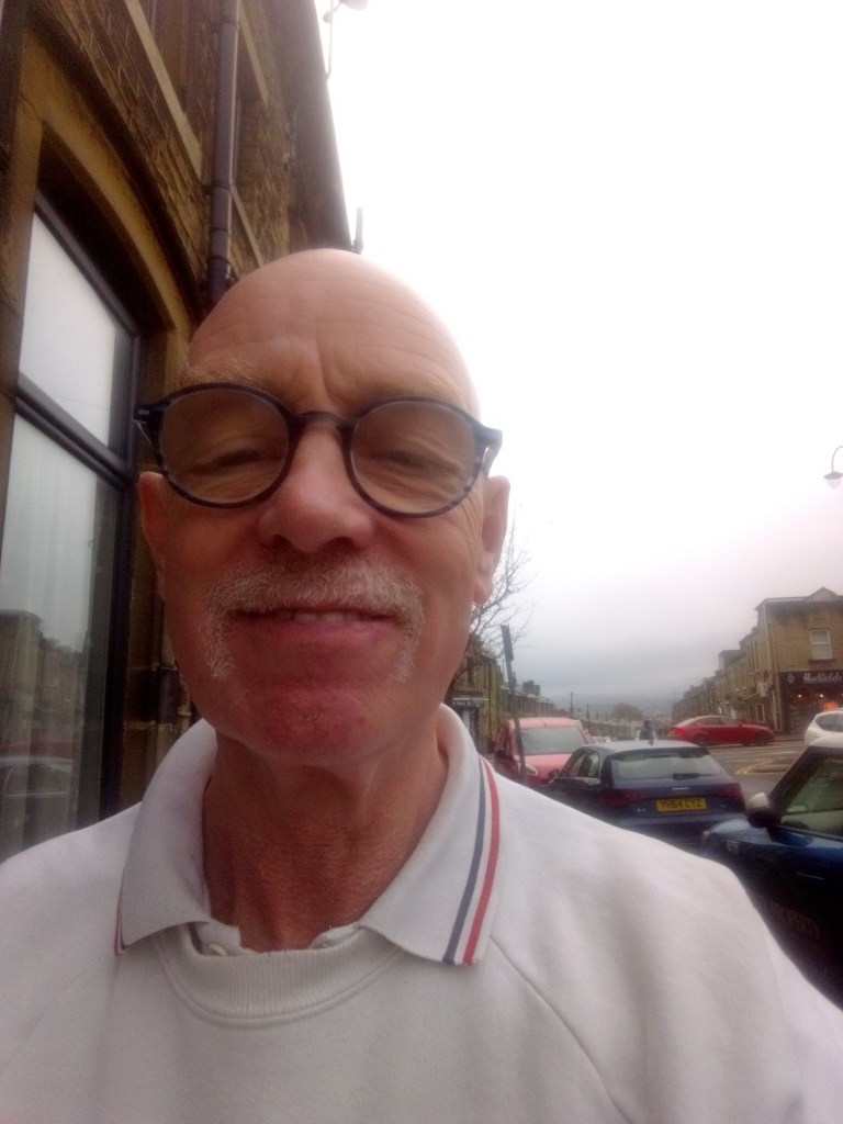 Me standing outside my house with the Pennine hills to the South of Huddersfield in the background.